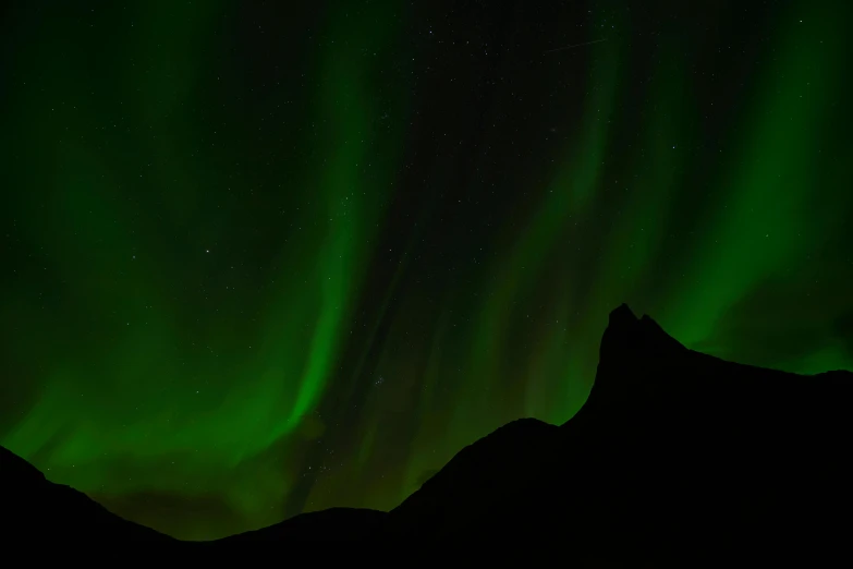 the aurora bore lights up the night sky, by Julia Pishtar, pexels contest winner, hurufiyya, black and green, peaks, up close, beautiful lighting uhd