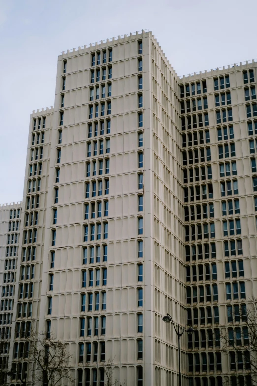 a very tall building with lots of windows, brutalism, opalescent palace, from wheaton illinois, medium-shot, low quality photo