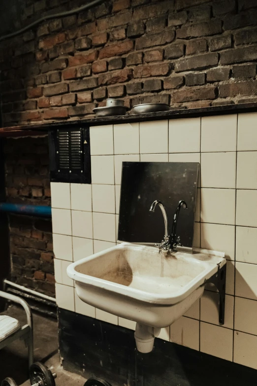 a white sink sitting next to a toilet in a bathroom, a photo, by Jan Tengnagel, unsplash, renaissance, a ghetto in germany, square, server, back room