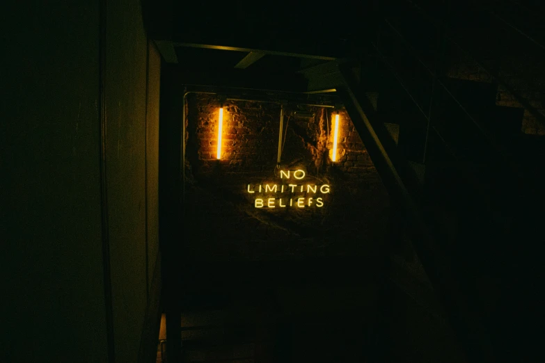a sign that is on the side of a building, pexels contest winner, lit up in a dark room, small steps leading down, low quality photo, lumine