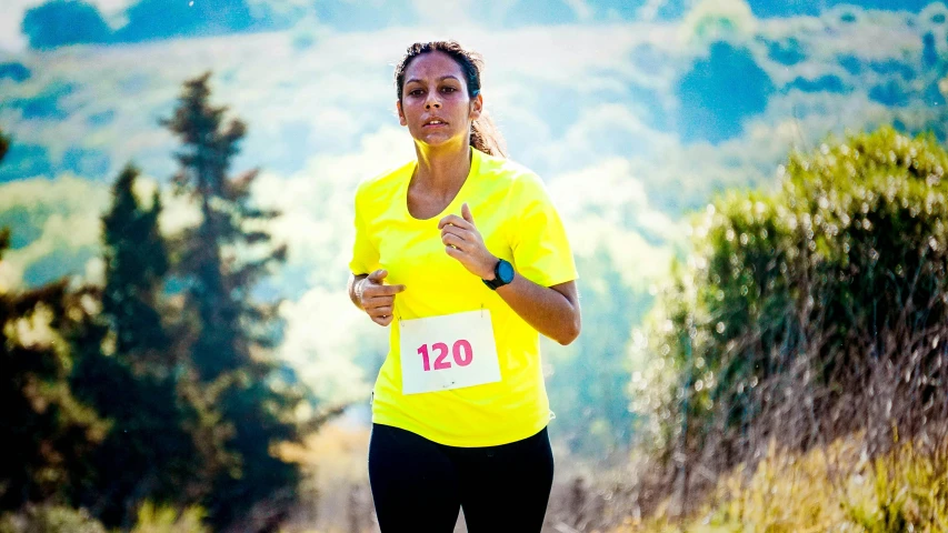 a woman in a yellow shirt is running, a portrait, pexels contest winner, 15081959 21121991 01012000 4k, in a race competition, beautiful surroundings, avatar image