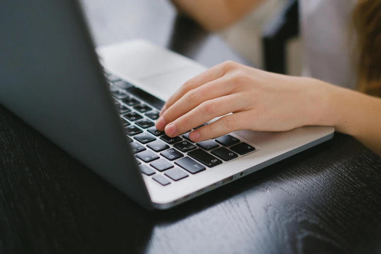 a close up of a person typing on a laptop, pexels, student, getty images, bottom angle, corinne day