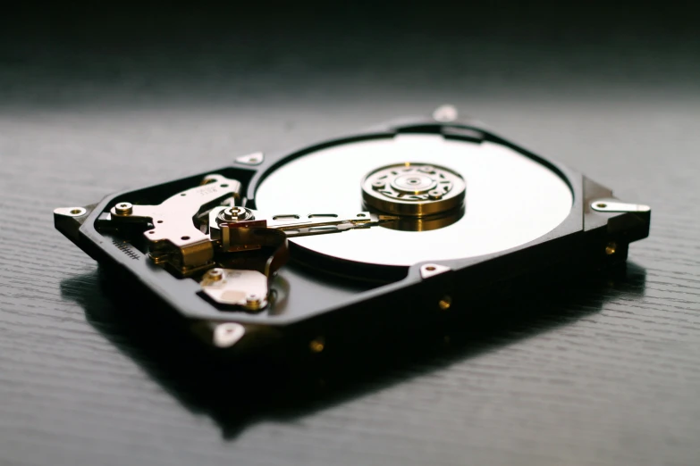 a hard drive sitting on top of a table, a computer rendering, unsplash, partially operational, opening shot, 2000s photo