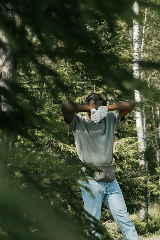 a man standing in the middle of a forest, dabbing, maintenance, african canadian, golf course