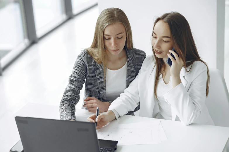 a couple of women sitting at a table with a laptop, professional image, thumbnail, 2019 trending photo, 15081959 21121991 01012000 4k