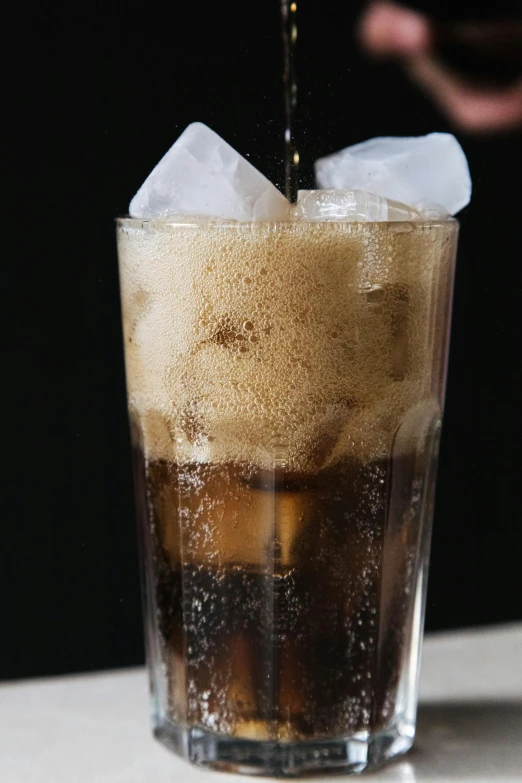 a close up of a drink being poured into a glass, inspired by Dorothy Coke, or black, freezing, dark skinned, thumbnail