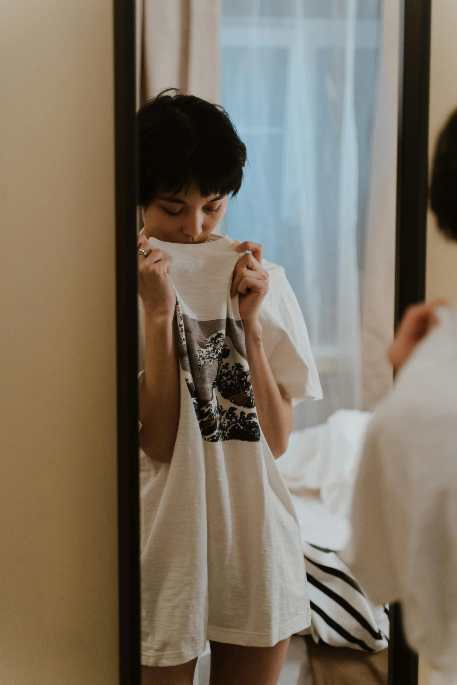 a woman that is standing in front of a mirror, dressed in a white t shirt, asian male, covered face, ignant