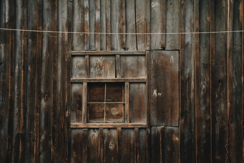 a close up of a window on a wooden building, by Elsa Bleda, pexels contest winner, square, old cabin, background image, ground - level medium shot