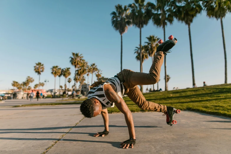 a man doing a handstand on a skateboard, pexels contest winner, with palm trees in the back, rollerskaters, profile image, laying down