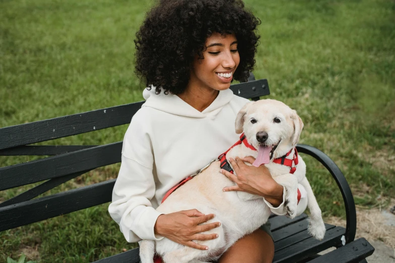 a woman sitting on a bench holding a dog, supportive, wearing a cute top, white, highly technical