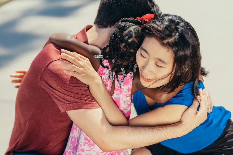 a couple of people that are hugging each other, pexels contest winner, hurufiyya, with a kid, louise zhang, varying ethnicities, summertime