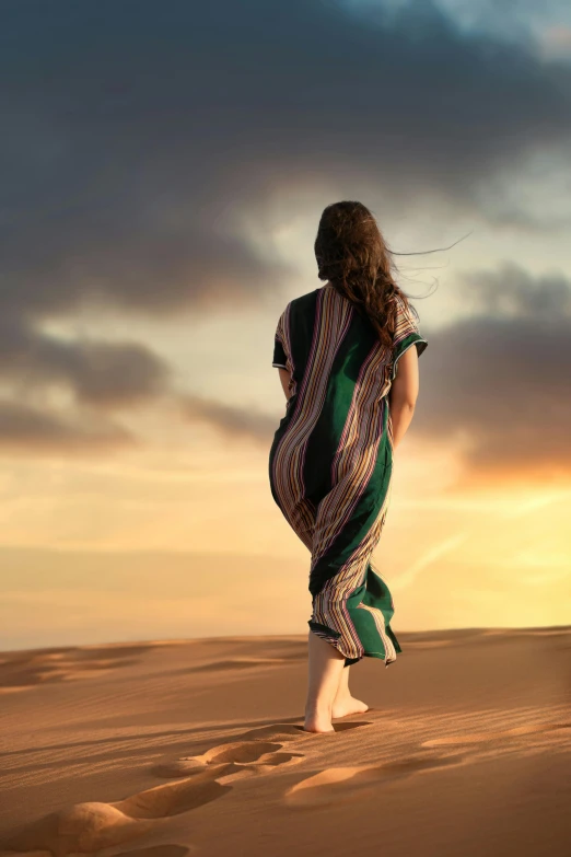 a woman standing on top of a sandy beach, inspired by Scarlett Hooft Graafland, trending on pexels, renaissance, beautiful arab woman, going forward to the sunset, dressed thobe, in the australian desert