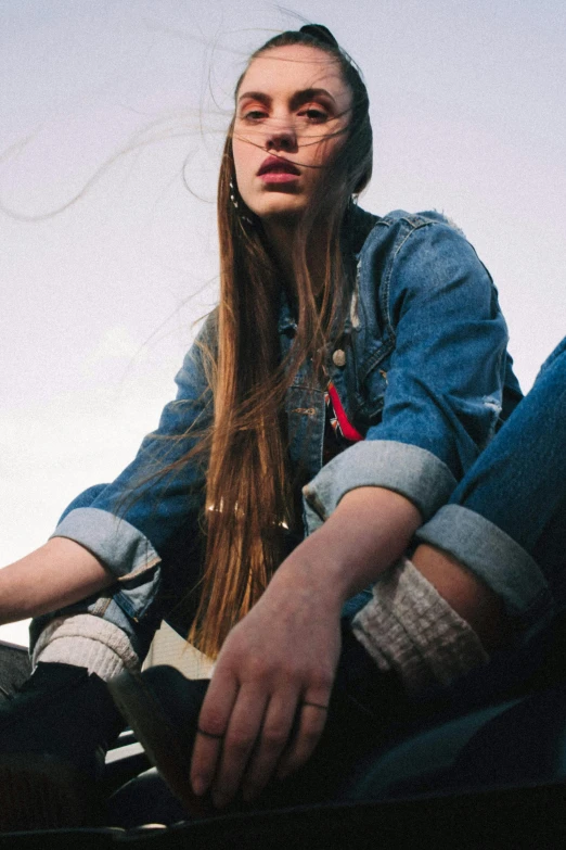 a young woman sitting on top of a skateboard, trending on pexels, renaissance, wearing a jeans jackets, woman with braided brown hair, woman with rose tinted glasses, young with long hair