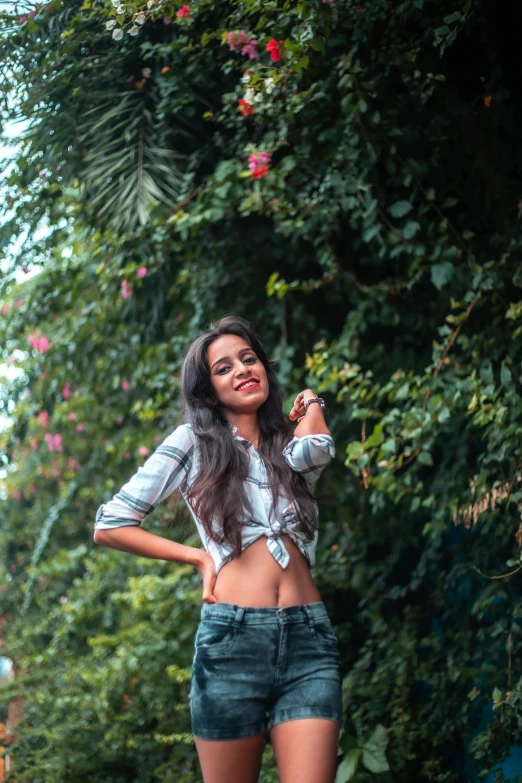 a beautiful young woman standing in the middle of a road, by Max Dauthendey, pexels contest winner, wearing a cropped tops, in garden, satisfied pose, avatar image