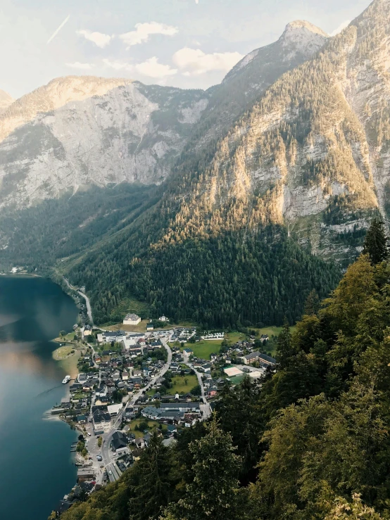 a large body of water surrounded by mountains, by Sebastian Spreng, pexels contest winner, happening, small town surrounding, alp, thumbnail, 8k cinematic shot