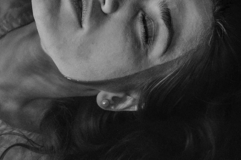 a black and white photo of a woman with her eyes closed, by Emma Andijewska, pexels, photorealism, upside - down, 🤤 girl portrait, high angle closeup portrait, 'i'm so tired