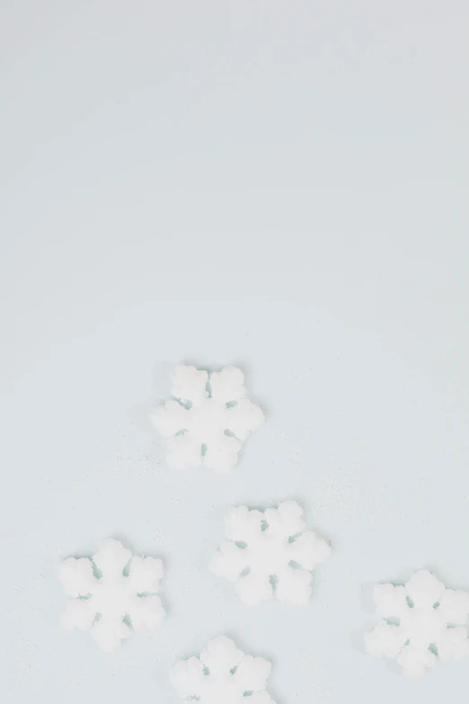 a bunch of snow flakes sitting on top of a table, a minimalist painting, trending on unsplash, white background : 3, promo image, candy decorations, background image