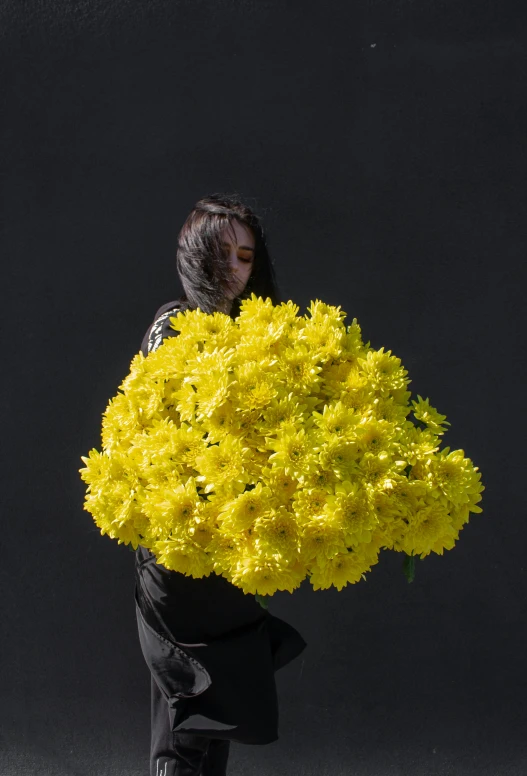 a woman holding a bunch of yellow flowers, an album cover, inspired by Yang J, unsplash, conceptual art, chrysanthemum eos-1d, against a deep black background, full frame image, the girl made out of flowers