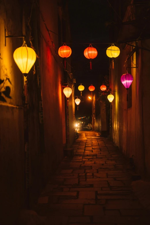 a narrow alley with lanterns lit up at night, happening, floating chinese lampoons, globes, hazy, colorful projections