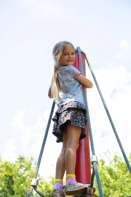 a little girl that is standing on a swing, inspired by Carl Larsson, unsplash, happening, activity play centre, slides, grey, in the sun