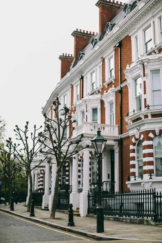 a couple of buildings sitting on the side of a road, pexels contest winner, neoclassicism, homes and gardens, victorian london, neighborhood, elegant highly detailed