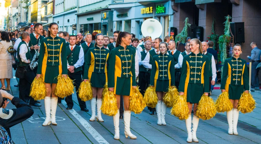 a group of people that are standing in the street, an album cover, by Jakob Gauermann, pexels contest winner, antipodeans, wearing elaborate green and gold, girl wearing uniform, lower saxony, concert