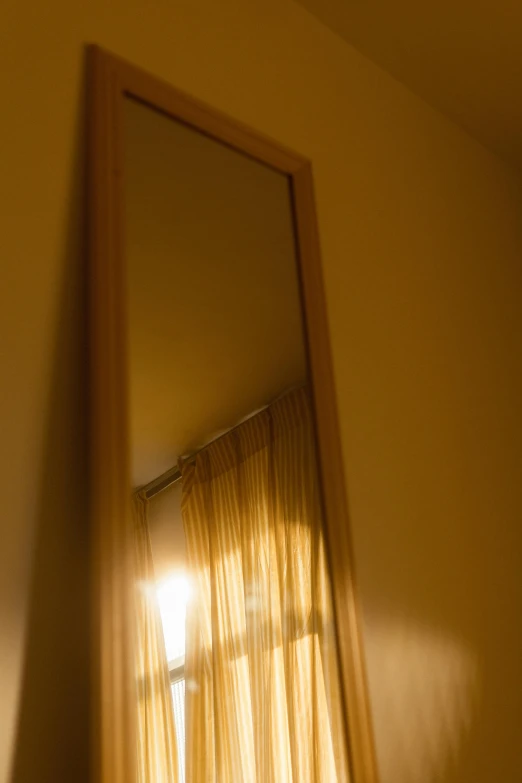a reflection of a window in a mirror, a picture, by Doug Ohlson, light and space, medium format. soft light, in my bedroom, warm yellow lighting, soft light - n 9