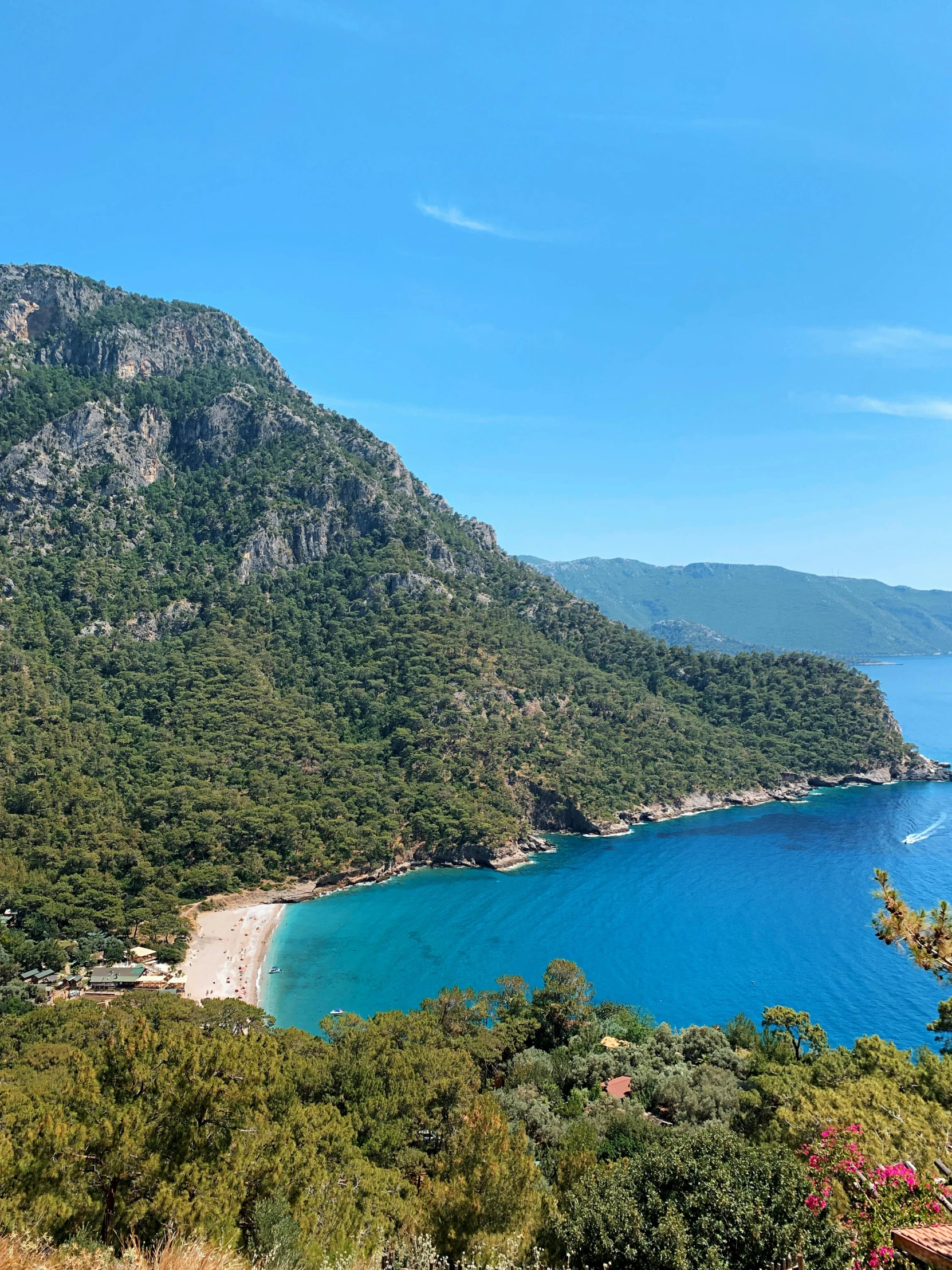 a large body of water sitting on top of a lush green hillside, hurufiyya, beaches, behind that turquoise mountains, profile image