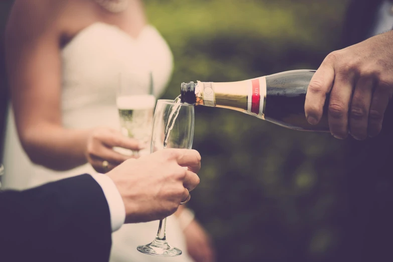 a man pouring a glass of wine into a woman's hand, pexels, happening, bride and groom, champagne, retro stylised, instagram post