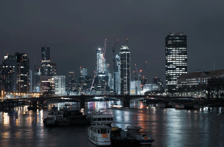 a group of boats floating on top of a river, by Joseph Severn, pexels contest winner, london at night, grey, foster and partners, skyline showing