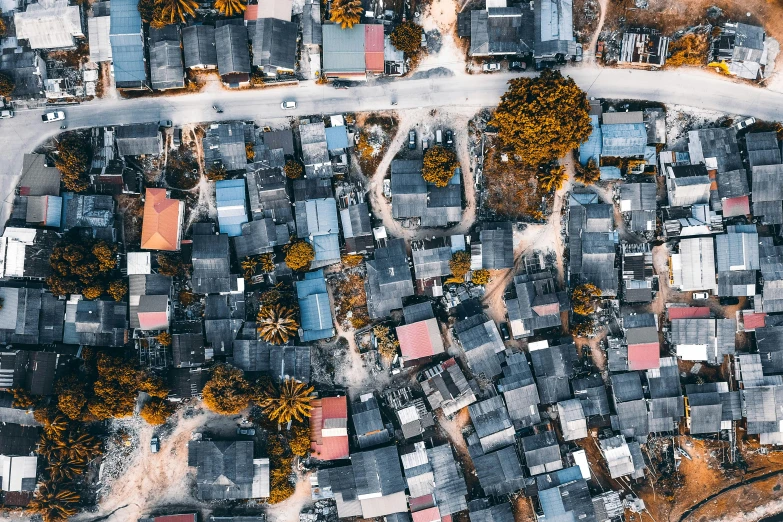 a bird's eye view of a small town, a colorized photo, by Daniel Lieske, trending on unsplash, burnt huts, poverty, perspective shot from the sky, orange roof