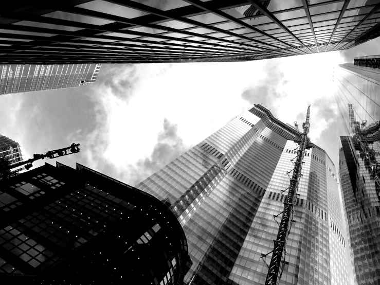 a black and white photo of skyscrapers in a city, by Adam Rex, gopro photo, construction, tall thin, various posed