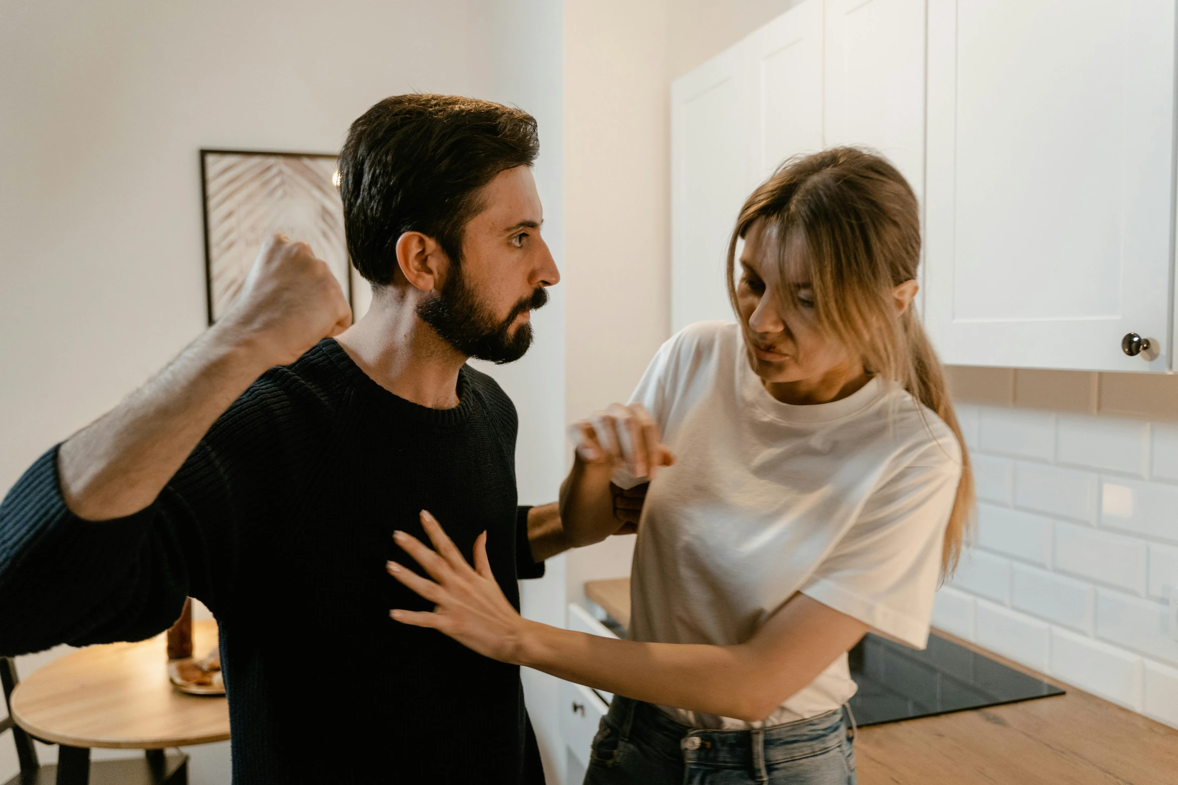 a man standing next to a woman in a kitchen, trending on pexels, antipodeans, in a fighting pose, australian, fighting each other, couple on bed