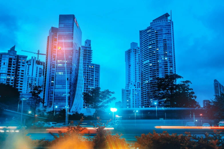 a city street filled with lots of tall buildings, pexels contest winner, hyperrealism, blue and red lighting, tropical coastal city, thumbnail, office building