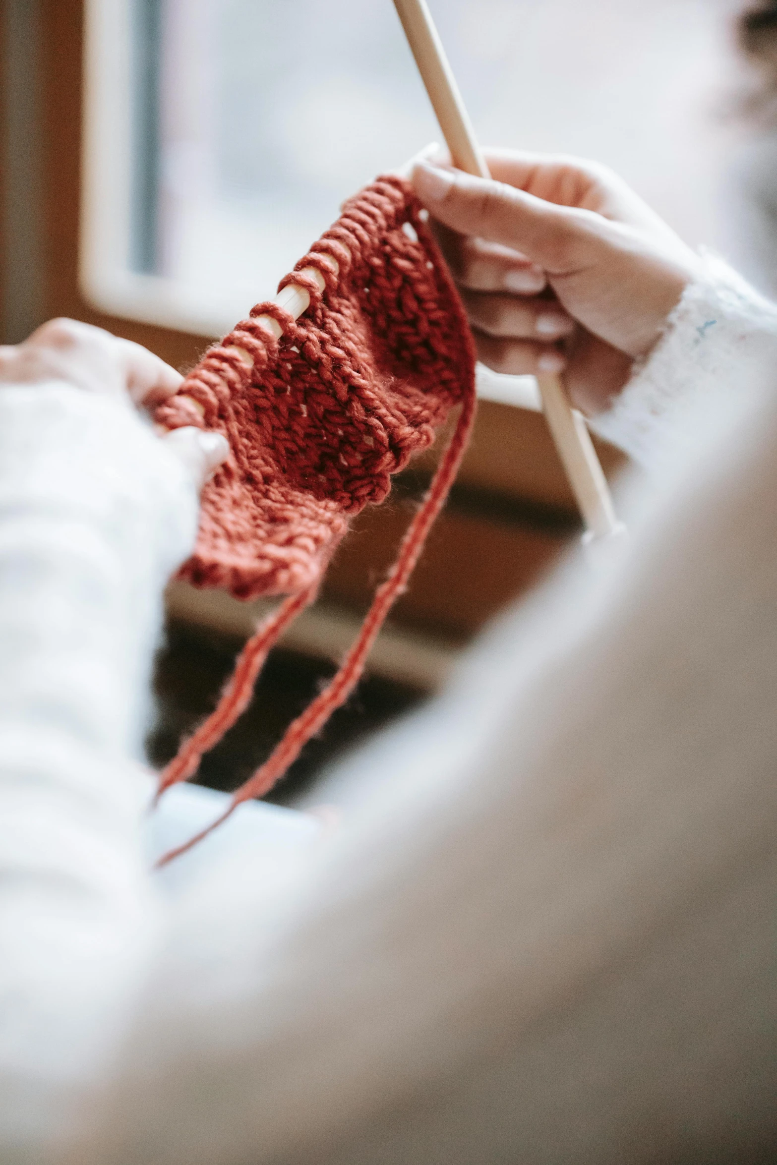 a woman knitting in front of a window, unsplash, red gloves, panties, promo image, red ocher