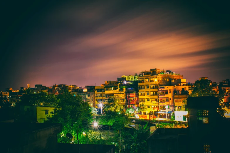 a view of a city at night from a rooftop, an album cover, by Ibrahim Kodra, pexels contest winner, guwahati, yellow, colorful”, nature photo