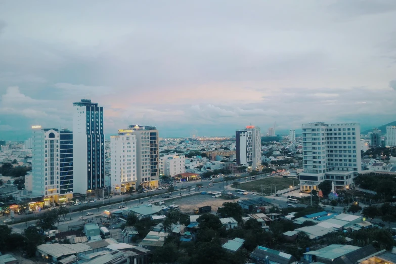 a view of a city from the top of a building, hoang long ly, unsplash 4k, tropical coastal city, white pale concrete city