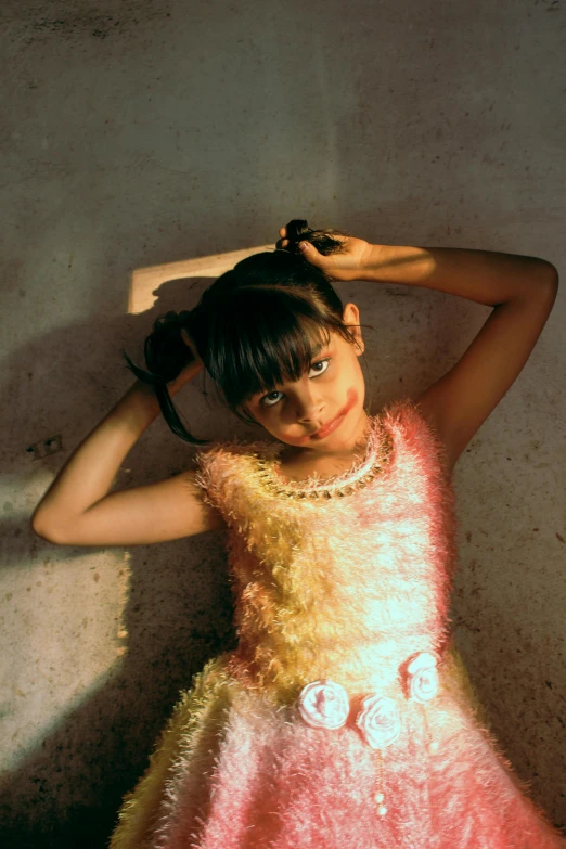 a little girl in a pink and yellow dress, an album cover, by Nathalie Rattner, hurufiyya, taken in 1 9 9 7, shimmering light, ameera al-taweel, portait image