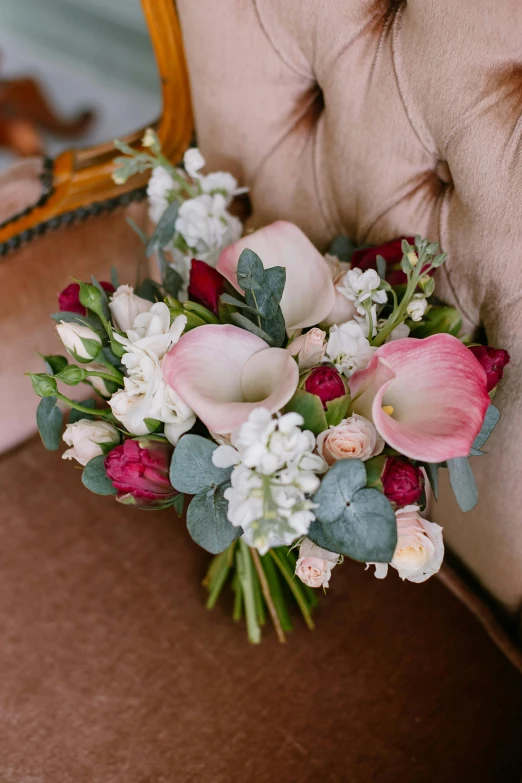 a bouquet of flowers sitting on top of a chair, white and pink, eucalyptus, rubrum lillies, clear curvy details