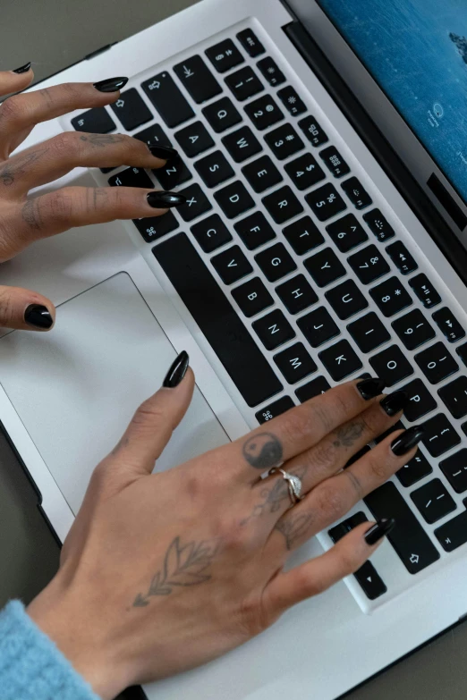 a close up of a person typing on a laptop, by Byron Galvez, black nails, tattooed, thumbnail, alexis franklin