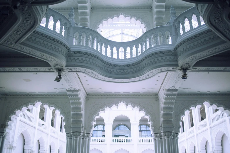 there is a clock in the middle of a building, inspired by Osman Hamdi Bey, unsplash contest winner, art nouveau, white sweeping arches, india, still from a wes anderson film, kuala lumpur