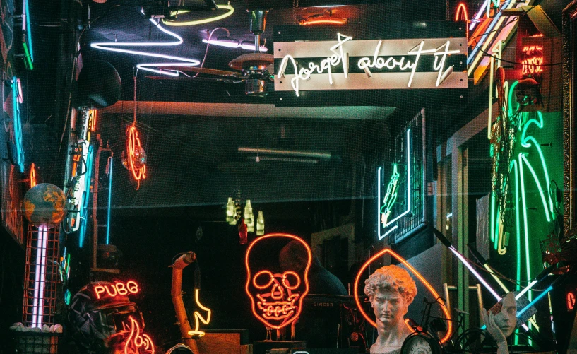 a woman standing in front of a store filled with neon signs, pexels contest winner, wires cables skulls, vivienne westwood, with glowing windows, berne hogarth