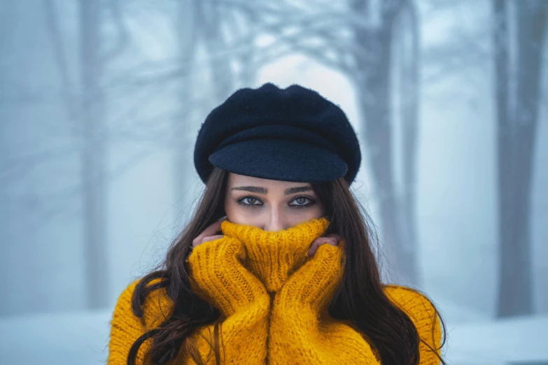 a woman wearing a yellow sweater and a black hat, a photo, by irakli nadar, trending on pexels, only snow i the background, avatar image, cute photo, hair covering eyes