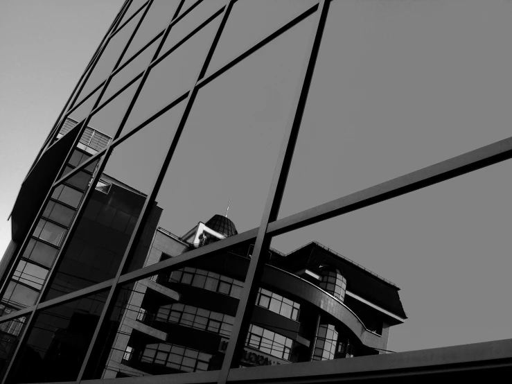 a black and white photo of a tall building, by Michalis Oikonomou, style of mirror\'s edge, glass houses, monochrome:-2, black & white