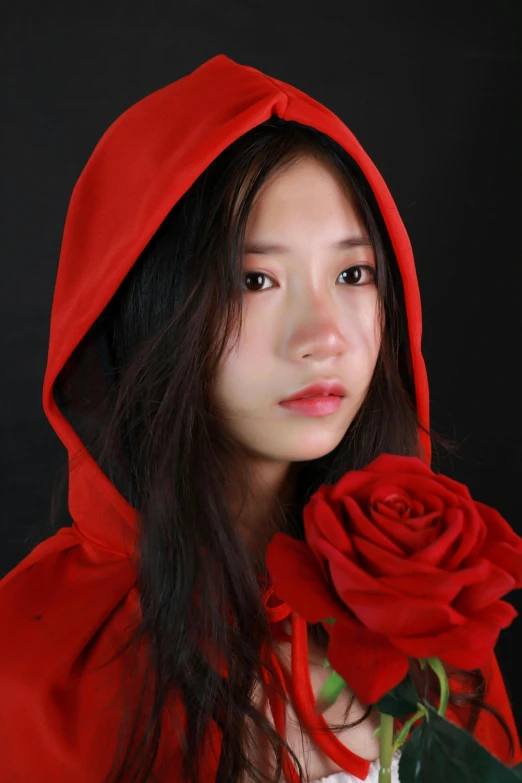 a woman in a red cloak holding a rose, an album cover, inspired by Jung Park, headshot profile picture, ((portrait)), young asian girl, shot with sony alpha