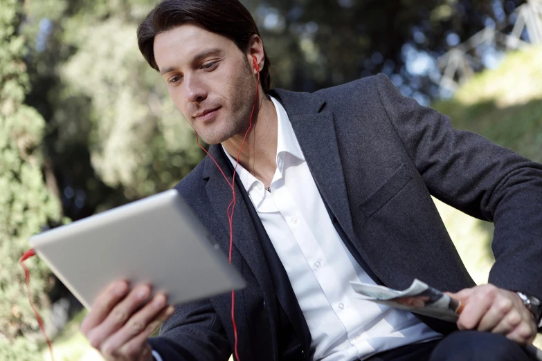 a man sitting on a bench with a tablet and headphones, a portrait, trending on pexels, wearing a blazer, avatar image, thumbnail, al fresco