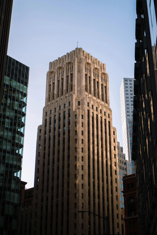 a tall building sitting in the middle of a city, an art deco sculpture, inspired by Hugh Ferriss, unsplash, late afternoon lighting, pitt, exterior view, san francisco