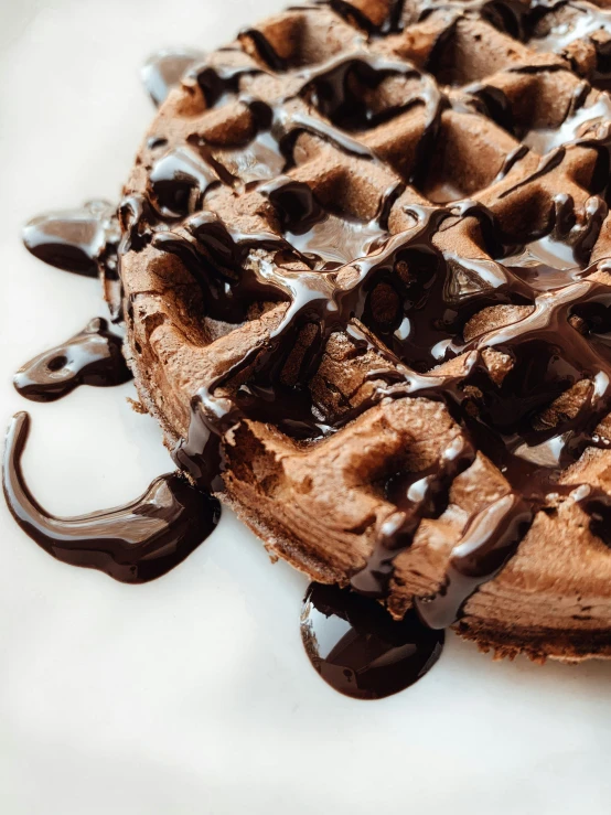 a chocolate waffle sitting on top of a white plate, by Robbie Trevino, pexels contest winner, chocolate frosting, dripped out, 🚿🗝📝, frontal close up