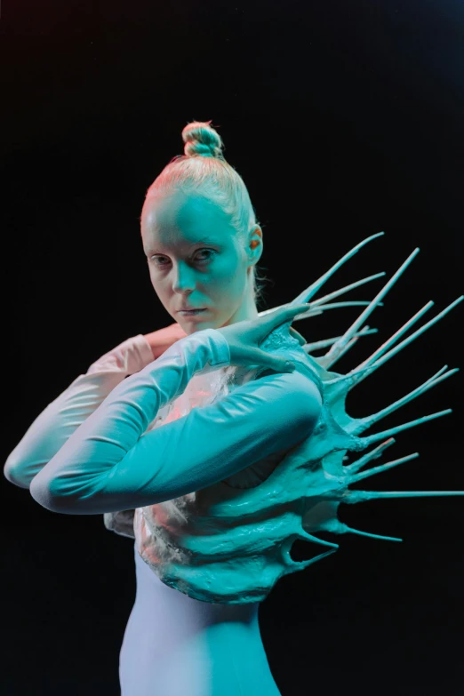 a woman in a bodysuit with spikes on her head, a surrealist sculpture, inspired by Louisa Matthíasdóttir, intense albino, hyperspace creature, promo photo, arms extended
