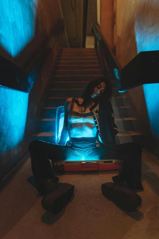 a man and a woman sitting on a set of stairs, an album cover, inspired by Elsa Bleda, trending on pexels, cyberpunk 2 0 y. o model girl, dimensional cyan gold led light, pharah, playboi carti